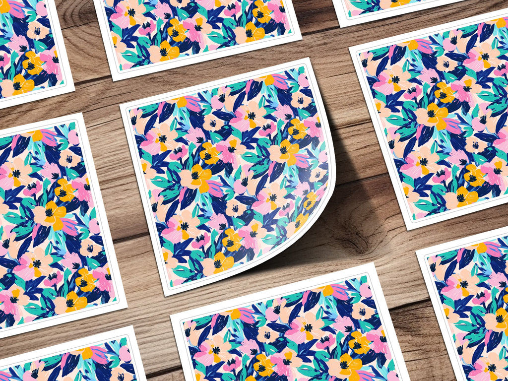 Floral patterned stickers with pink, yellow, and blue flowers on a wooden surface.