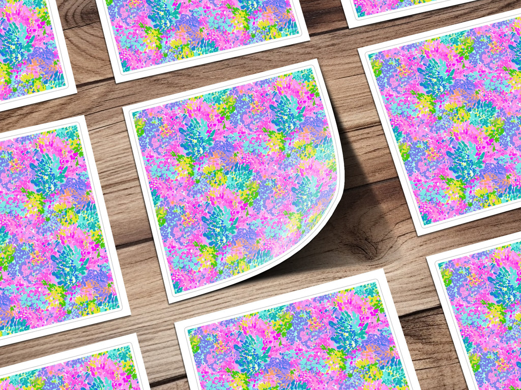 Colorful floral pattern on square cards scattered on a wooden surface.