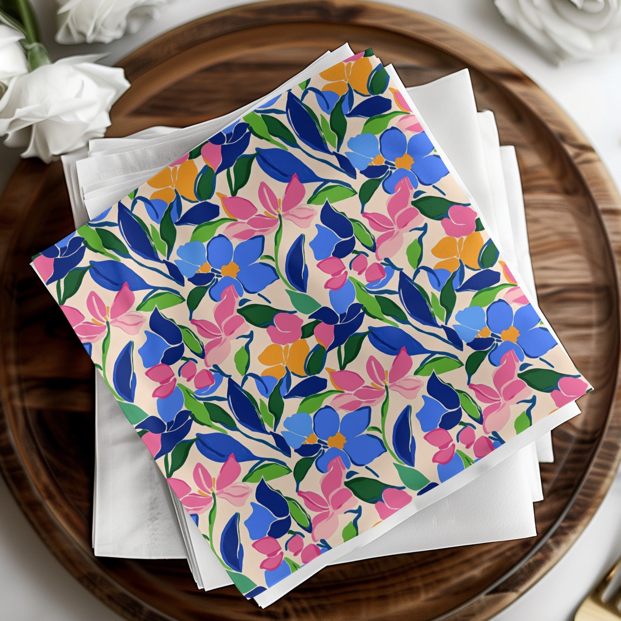 Stack of napkins with blue, pink, and yellow floral pattern.