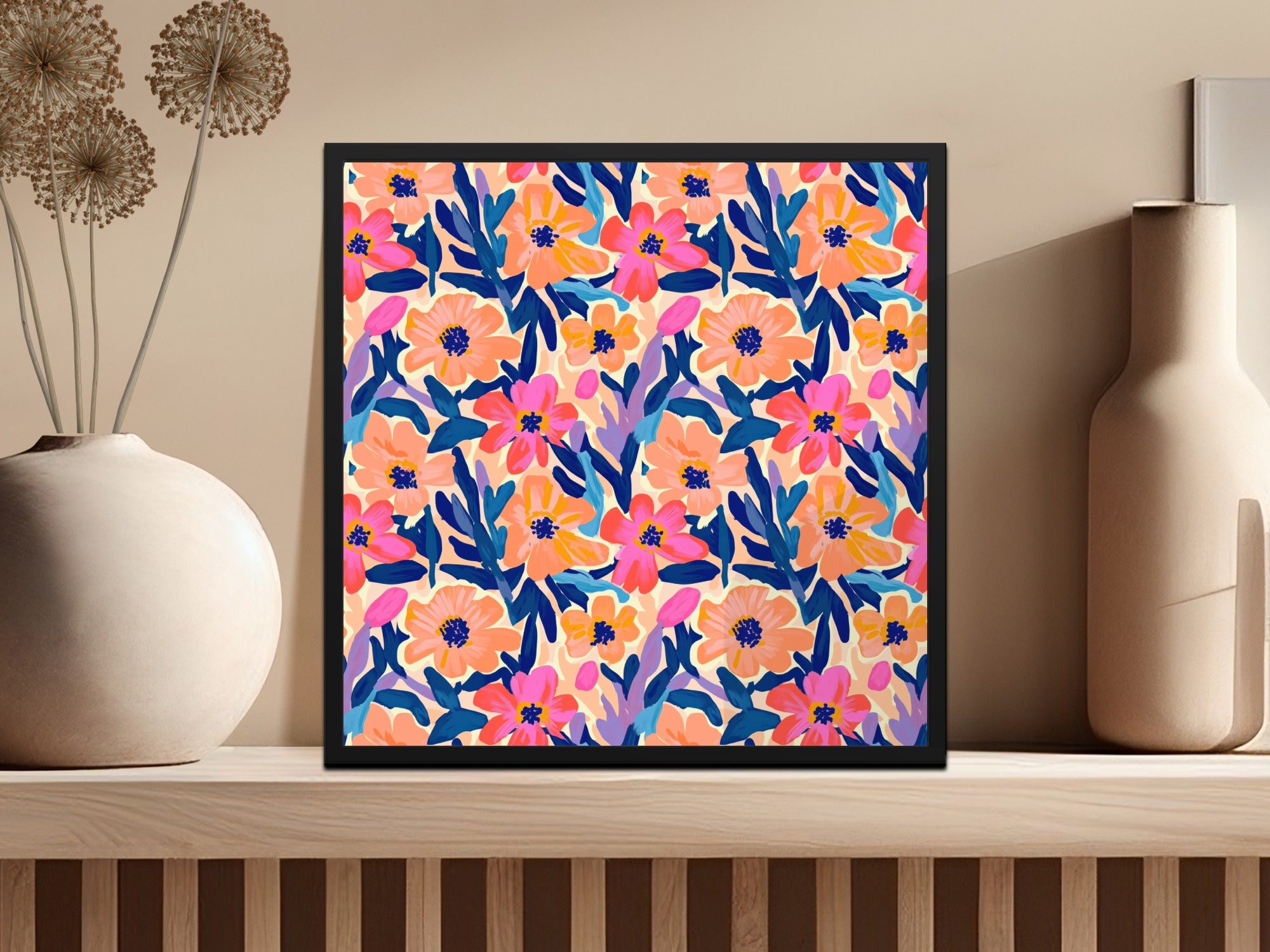 Colorful floral pattern artwork in a black frame on a shelf.