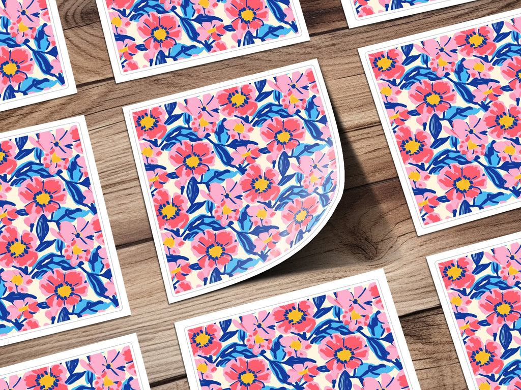 Floral pattern stickers on a wooden background, one sticker peeled.