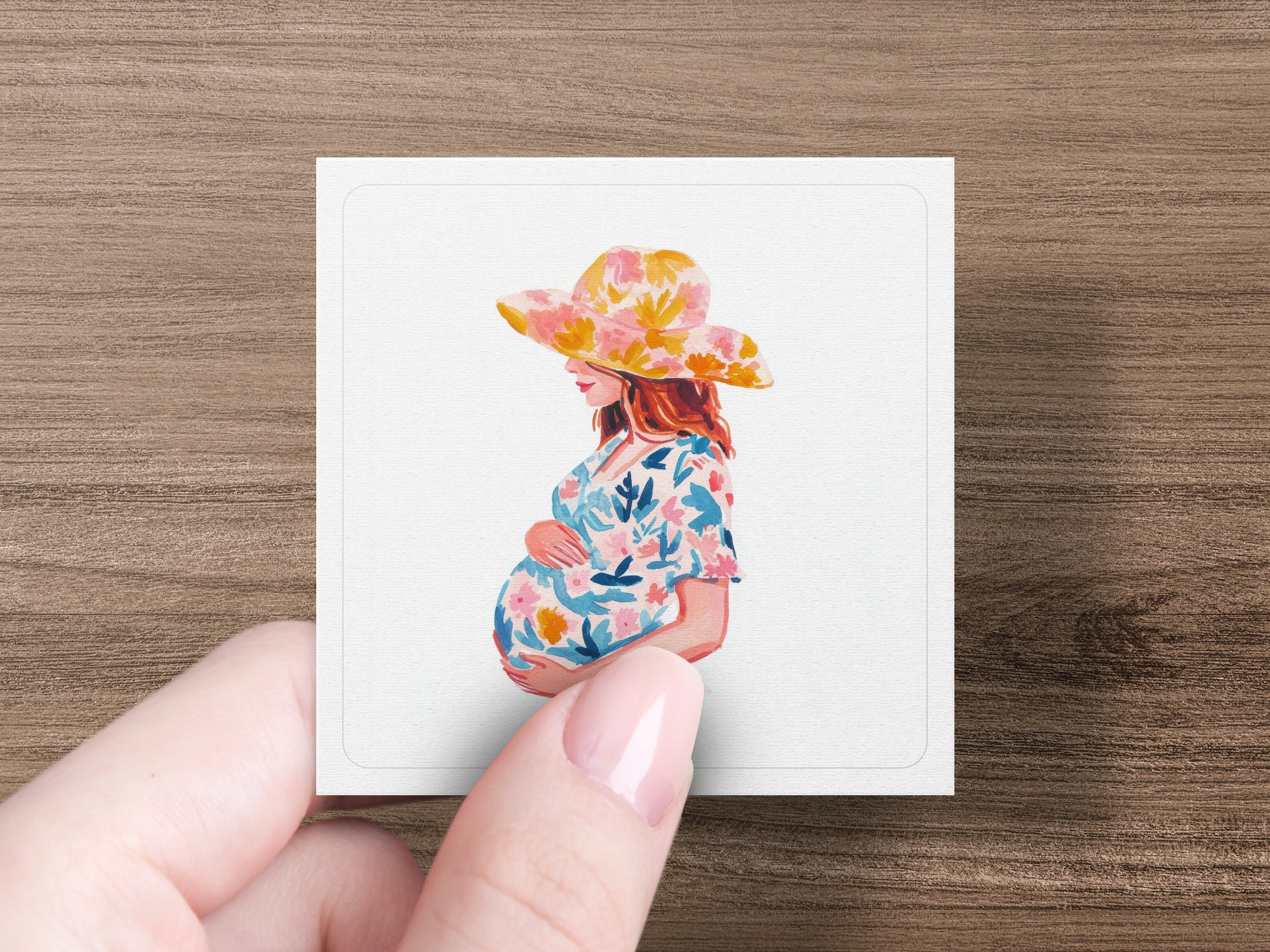 Pregnant woman in a floral dress and hat, profile view, holding belly.