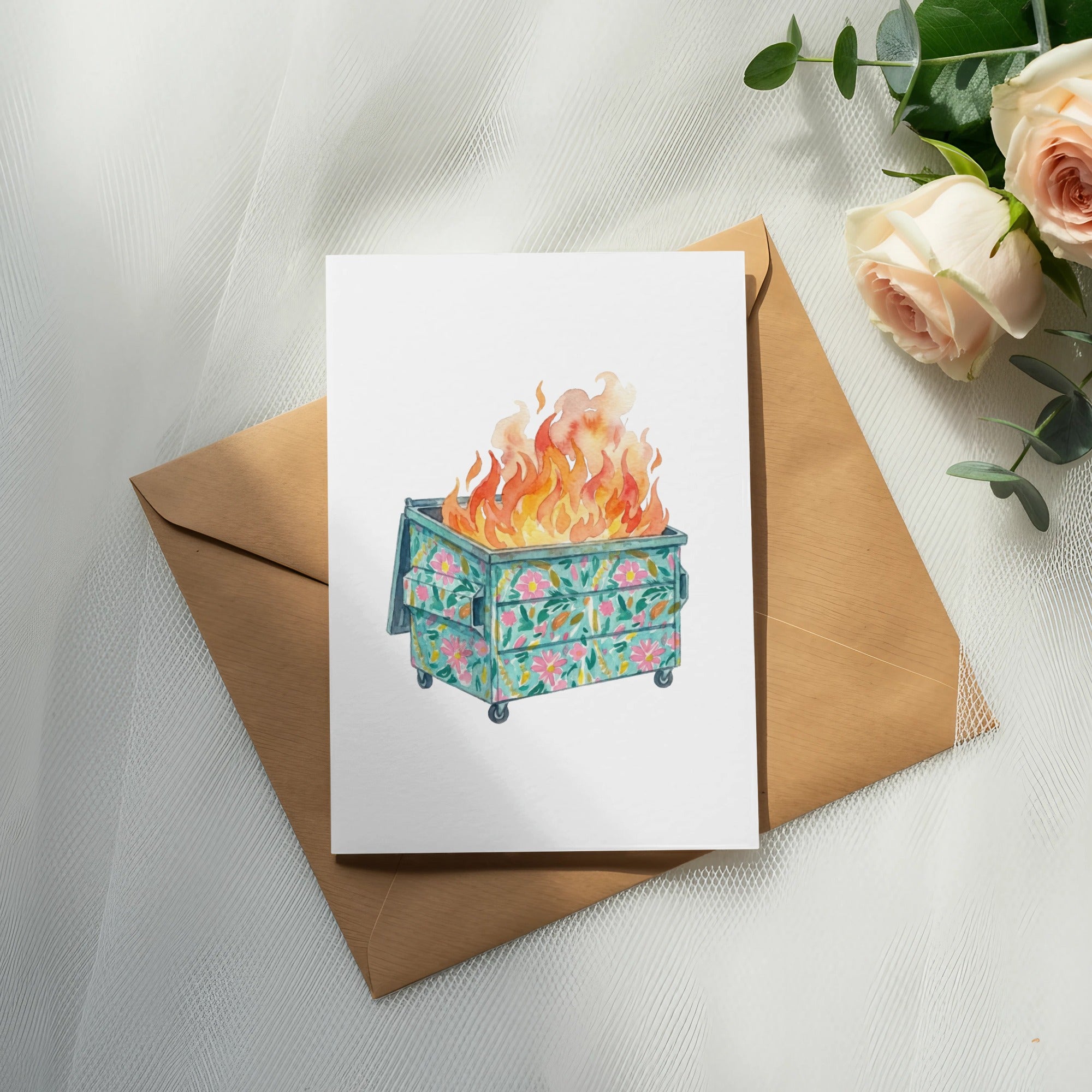Floral dumpster fire illustration on a card, resting on an envelope.