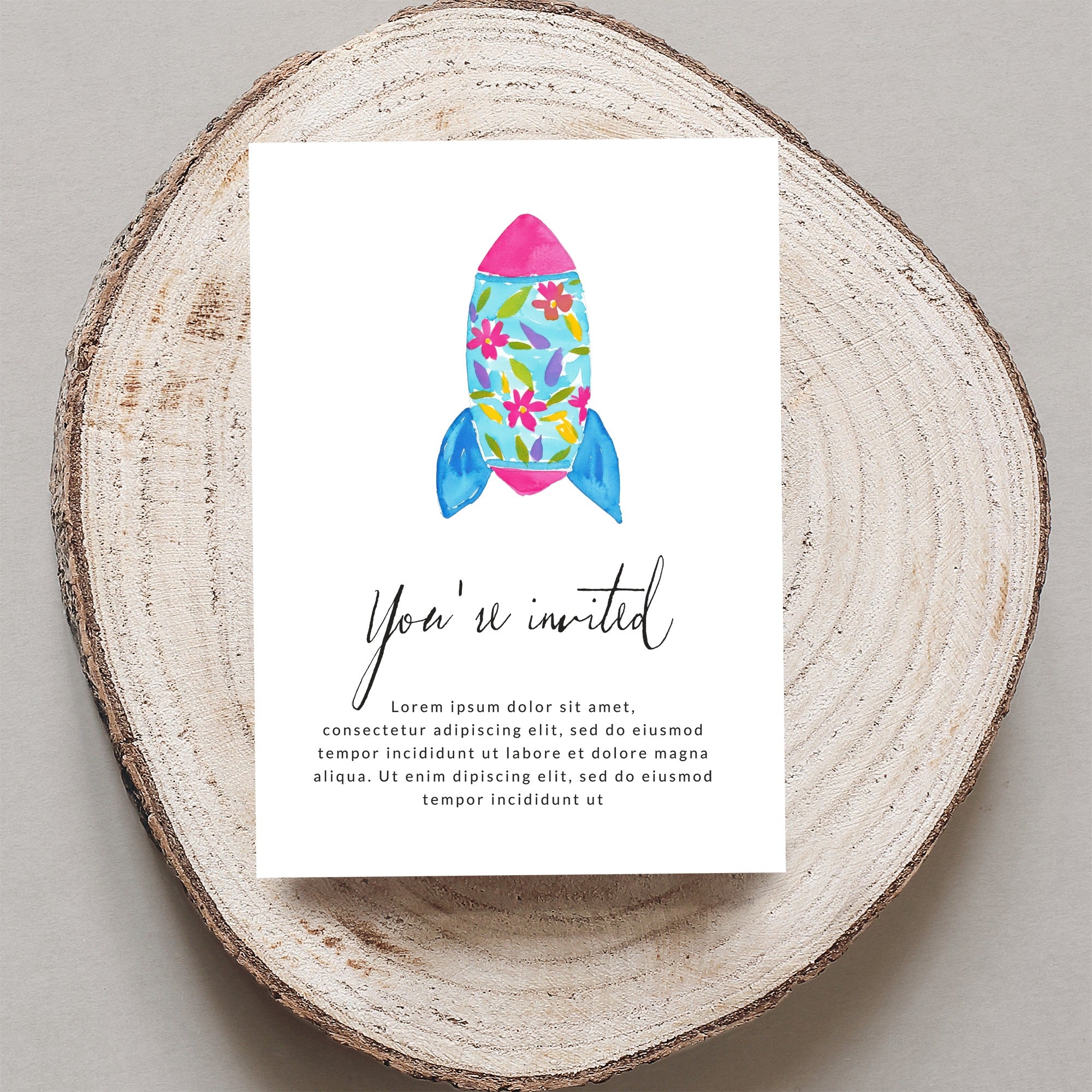 Invitation card with a rocket design and "You're invited" text.