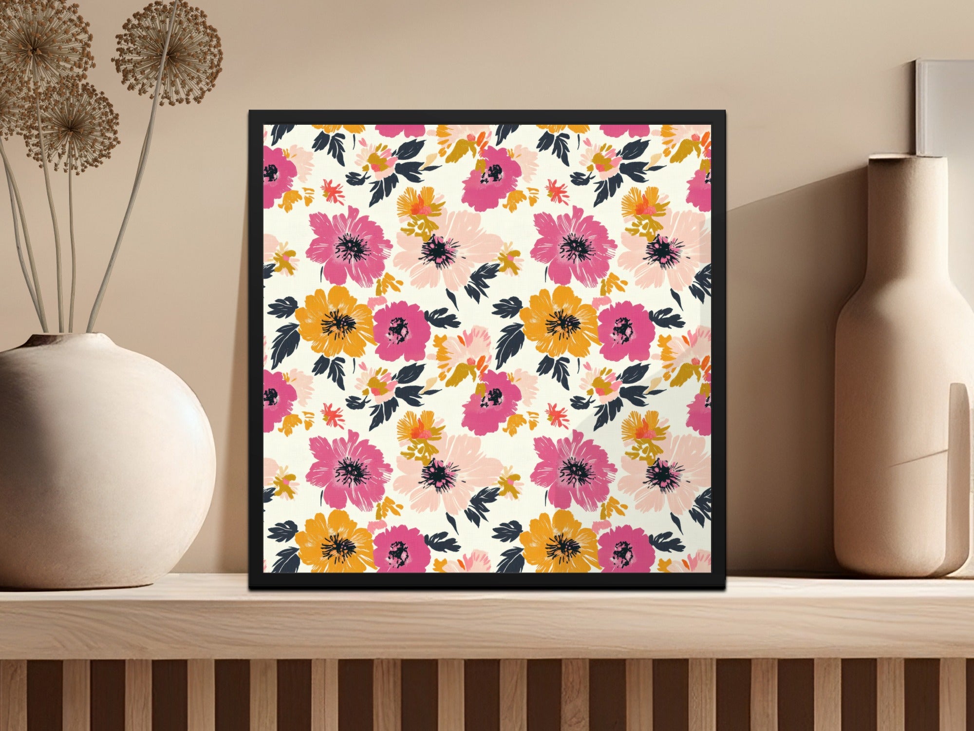 Framed artwork with a colorful floral pattern hangs on a shelf.