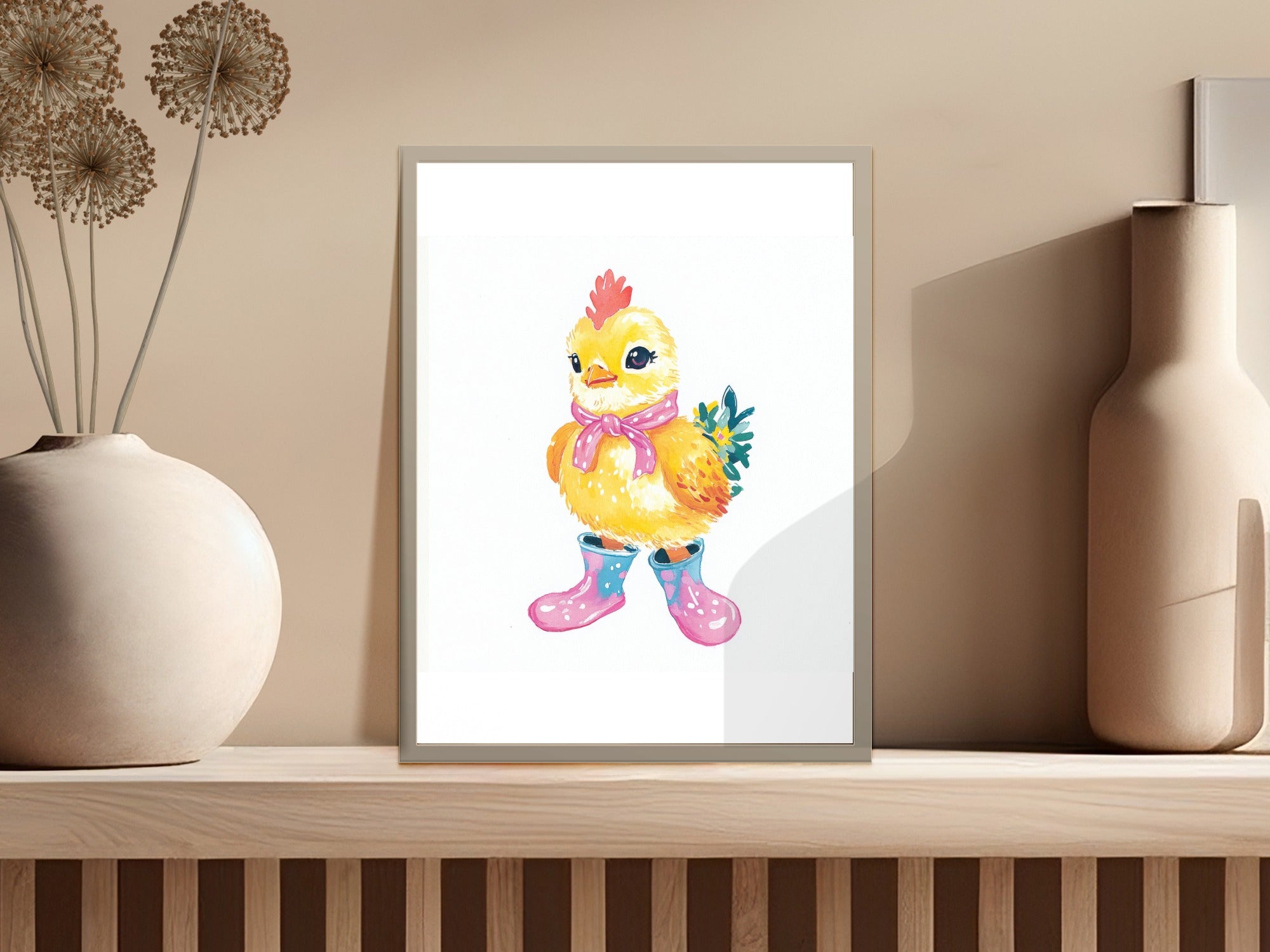 Cute cartoon chick wearing pink boots and a scarf in a framed picture.