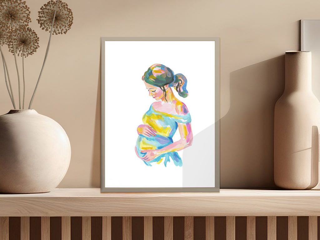 Watercolor painting of a pregnant woman with colorful dress, displayed on a shelf.