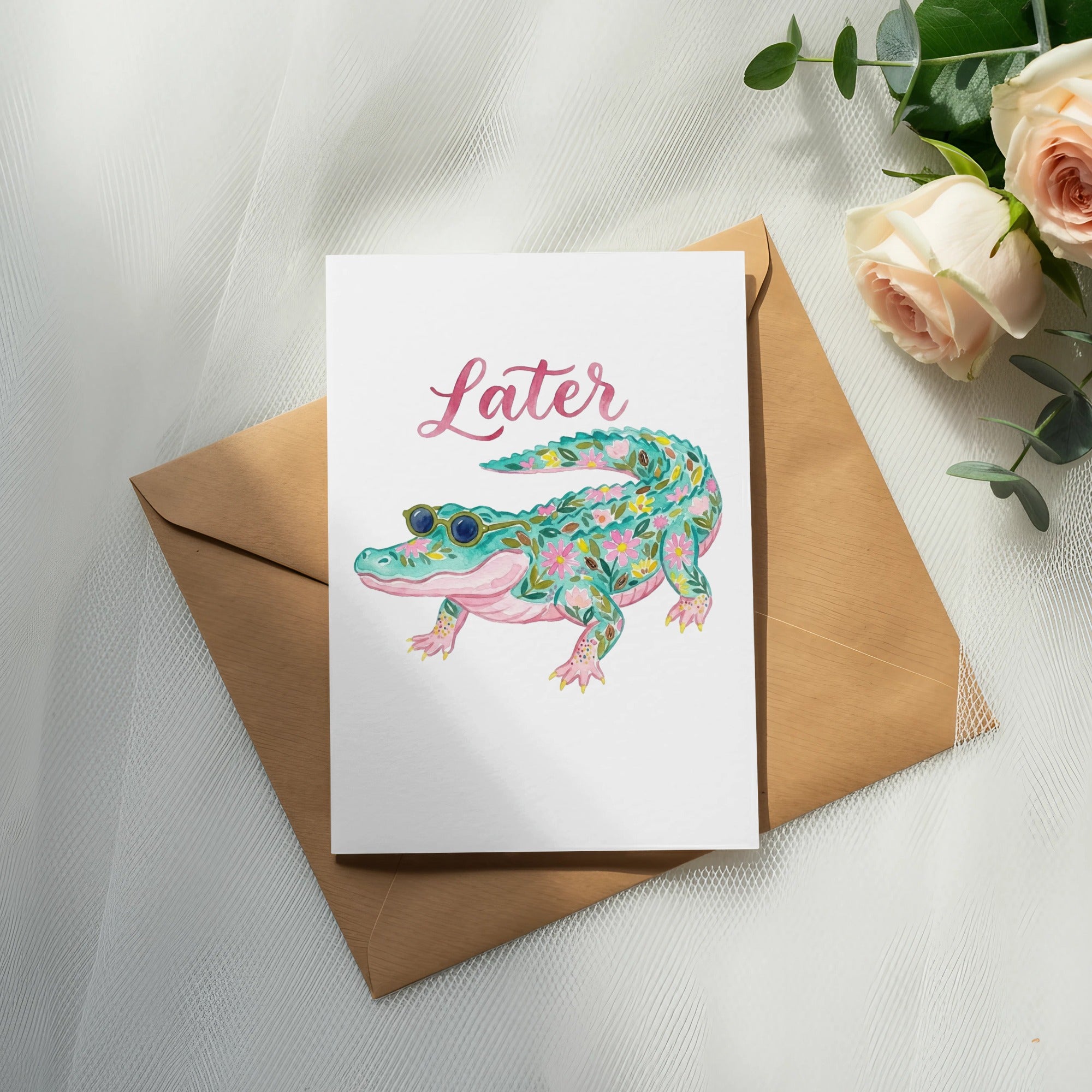 Card with floral alligator and "Later" text, resting on an envelope.