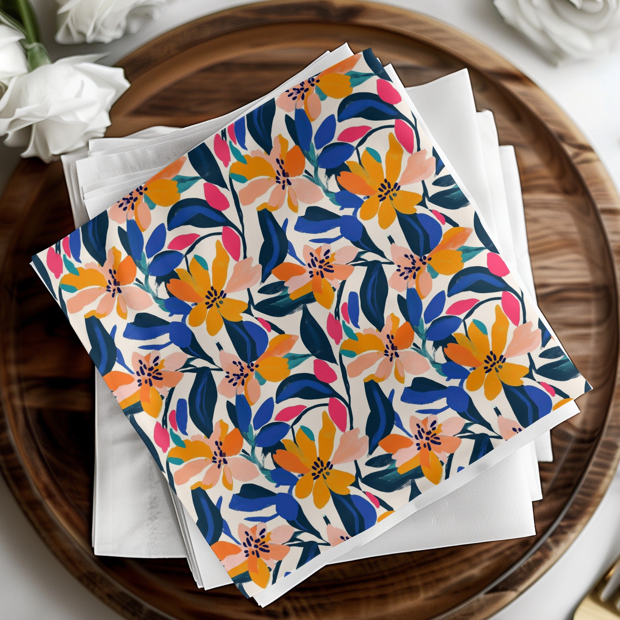 Fabric napkin with colorful floral pattern on a wooden tray.