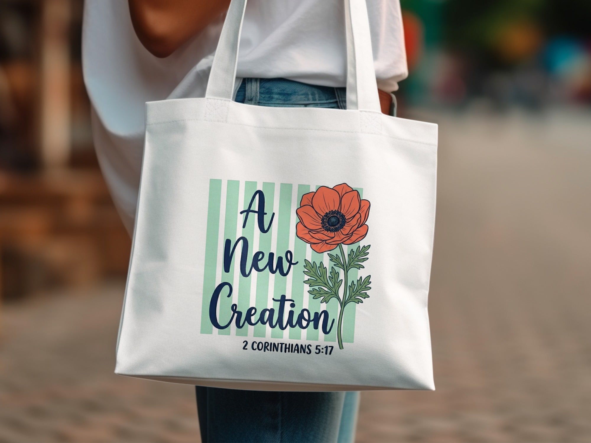 White tote bag with floral design and scripture "A New Creation, 2 Corinthians 5:17".