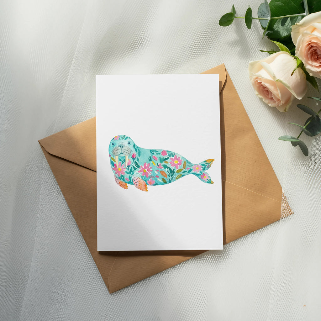 Card with floral walrus illustration on kraft envelope, with roses.