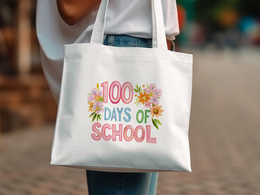 White tote bag with "100 Days of School" text and floral decorations.