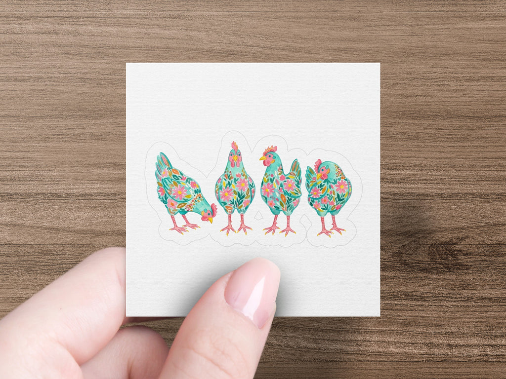 Four colorful, floral-patterned chickens lined up on a white background.