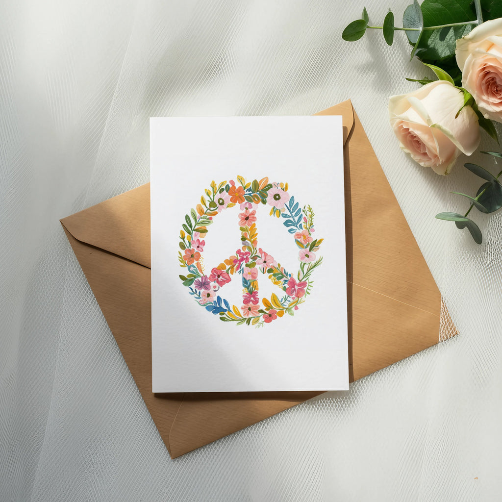 White card with floral peace sign on brown envelope with roses.