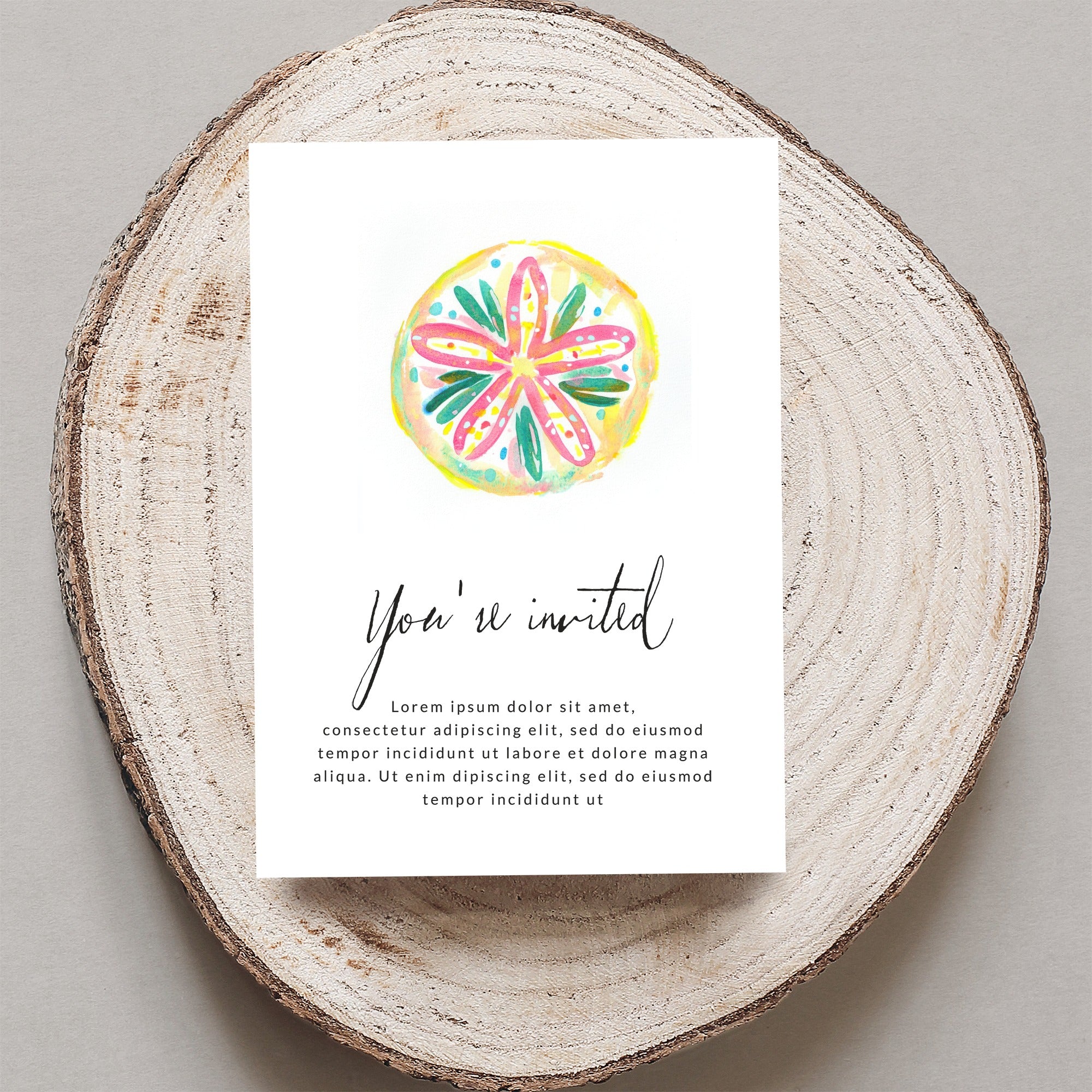 Invitation card with "You're invited" text and watercolor citrus slice.