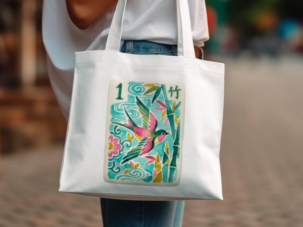 White tote bag with a colorful illustration of a bird and bamboo.