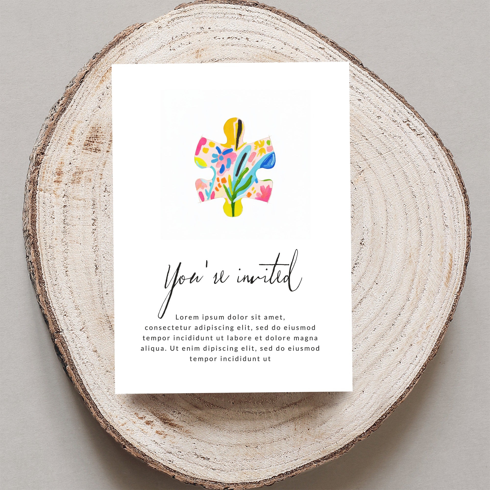 Invitation with "You're invited" and floral puzzle piece.