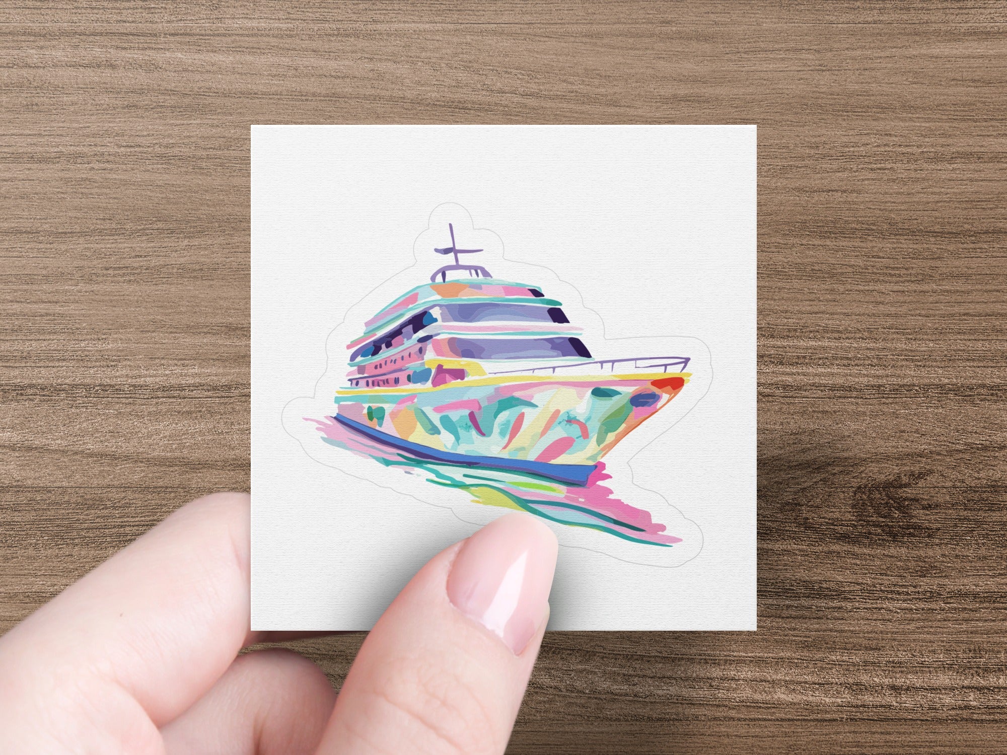 Colorful abstract yacht illustration on a white sticker held by a hand.