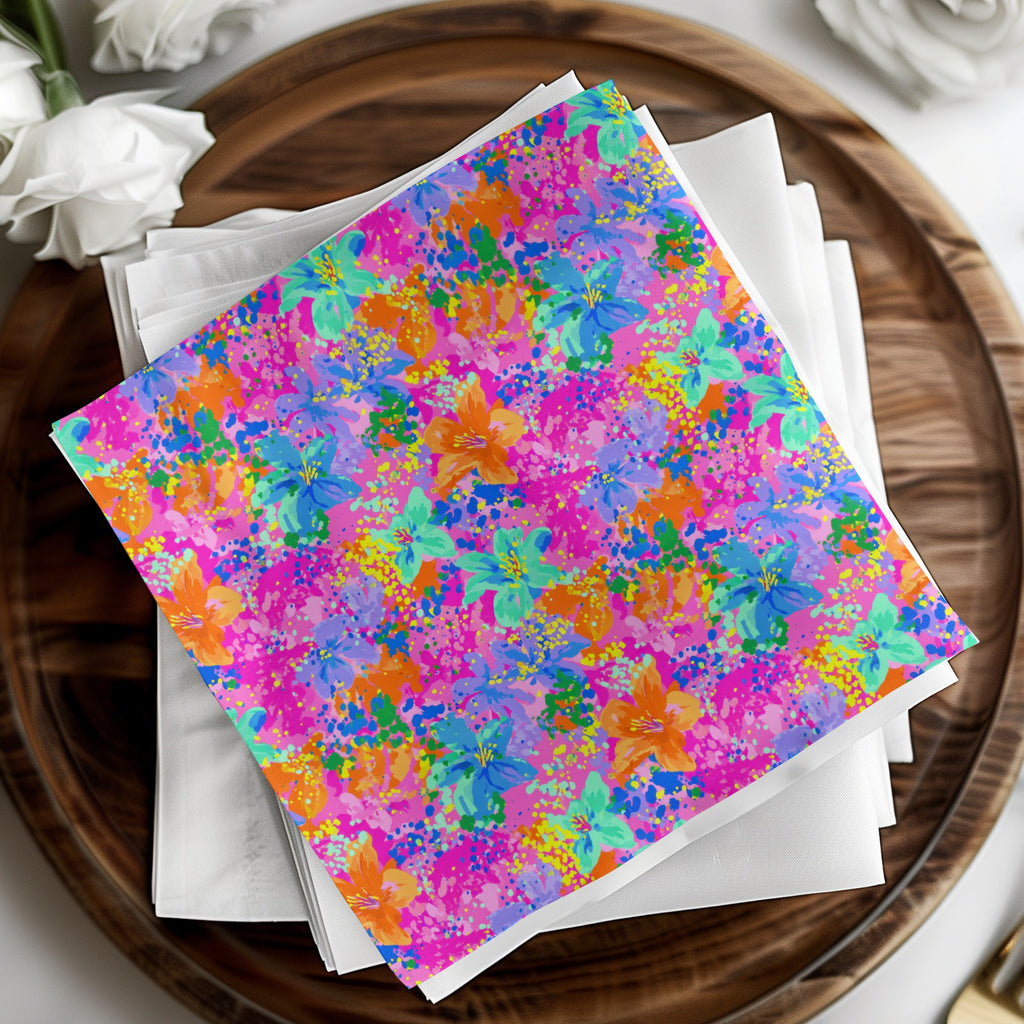 Paper cocktail napkins with colorful floral and splatter print on white napkins.