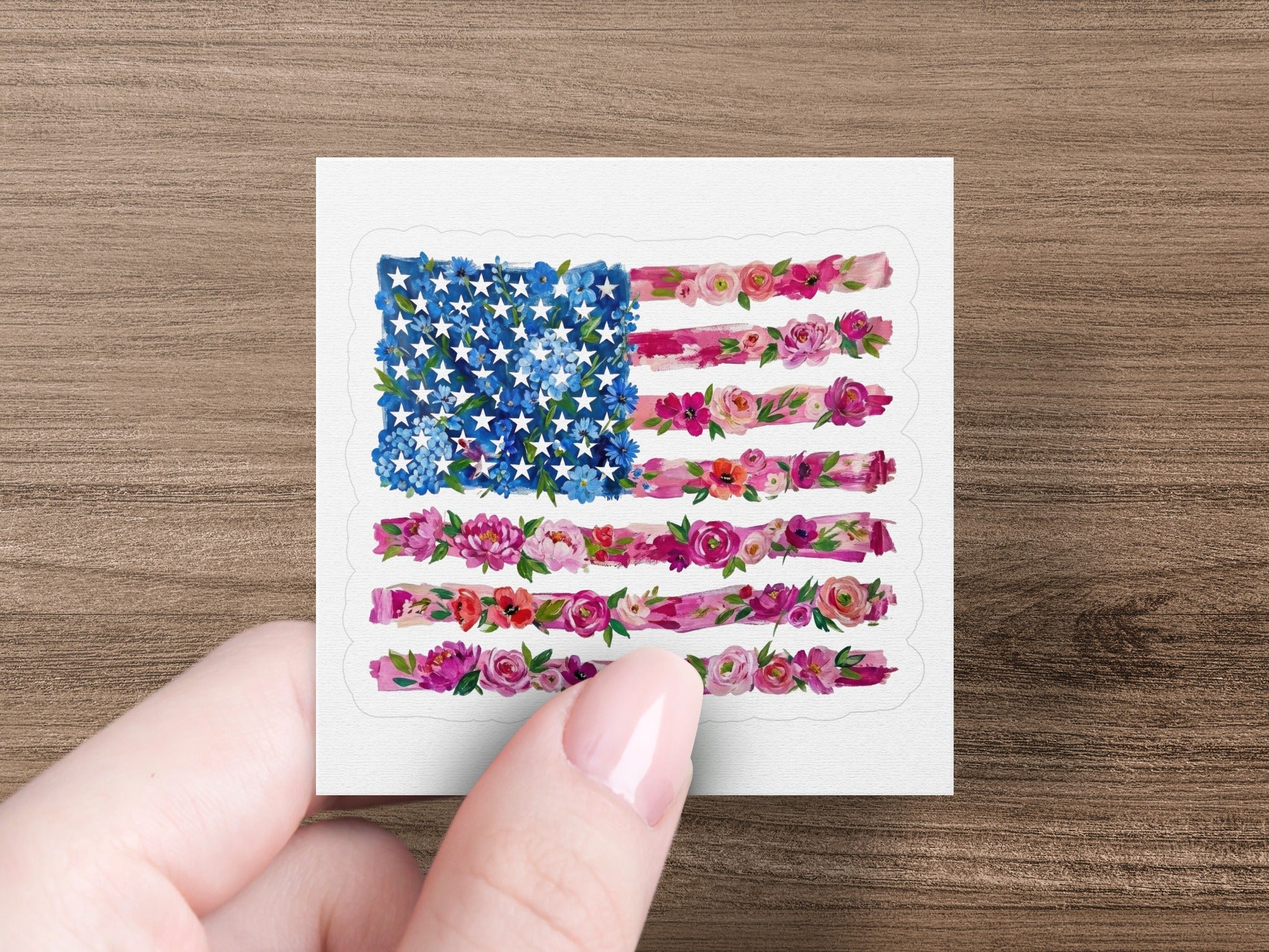 American flag made of flowers held by a hand.
