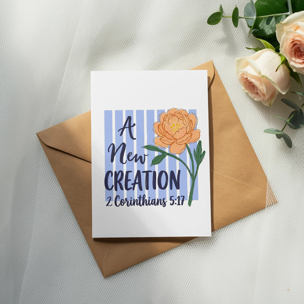 Card with "A New Creation" text and floral illustration, over envelope with roses.