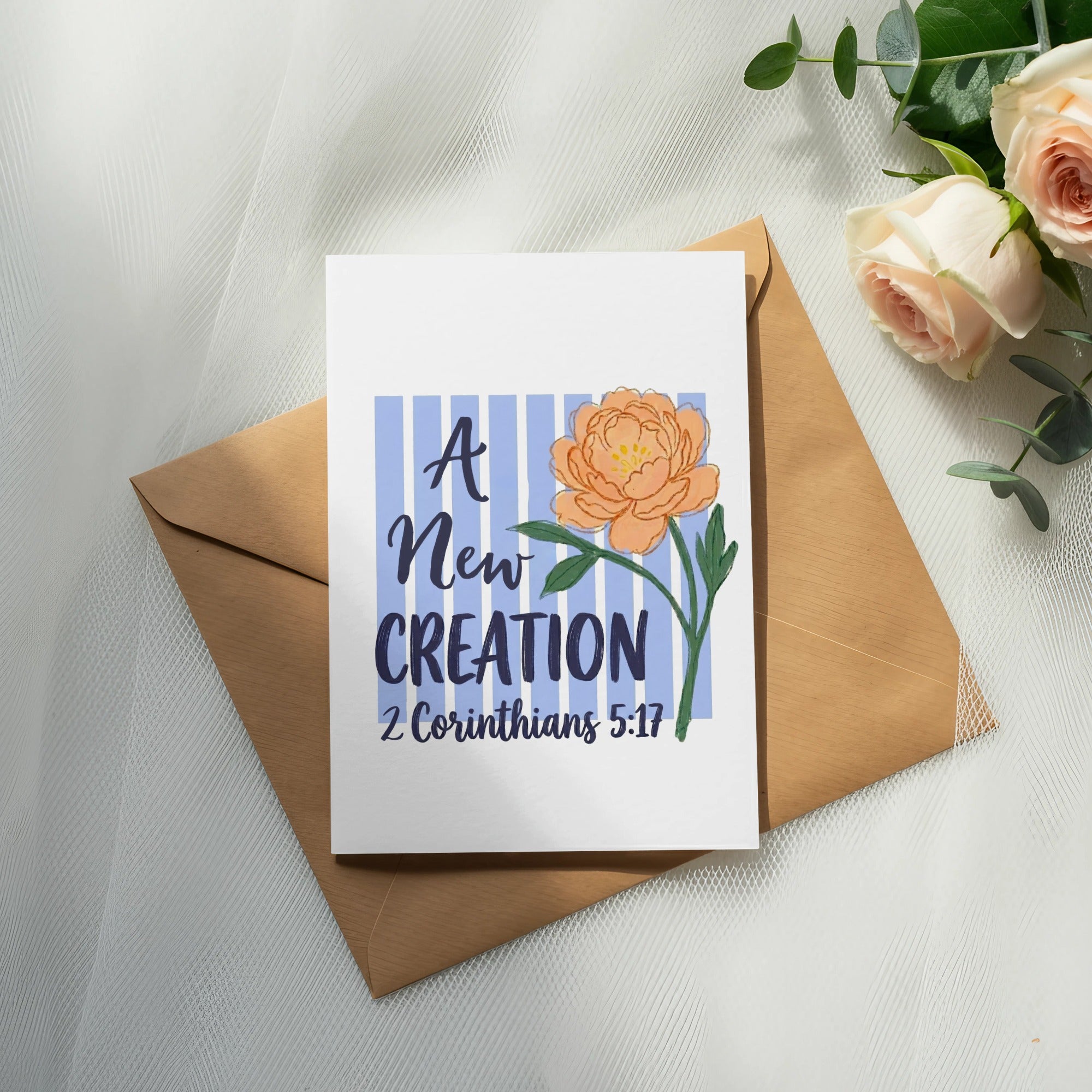 Card with "A New Creation" text and floral illustration, over envelope with roses.