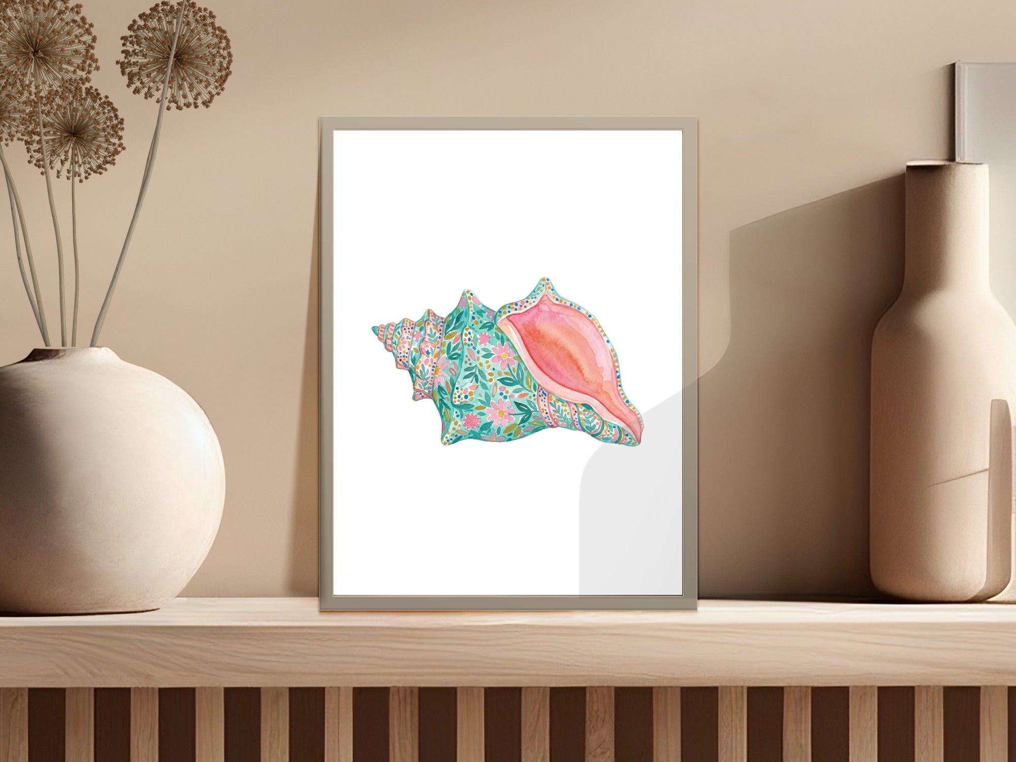 Watercolor painting of a pink conch shell with colorful floral patterns.