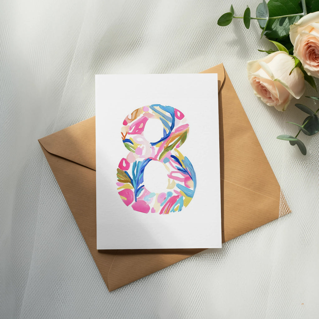 Card with colorful abstract "8" design on brown envelope, with roses.