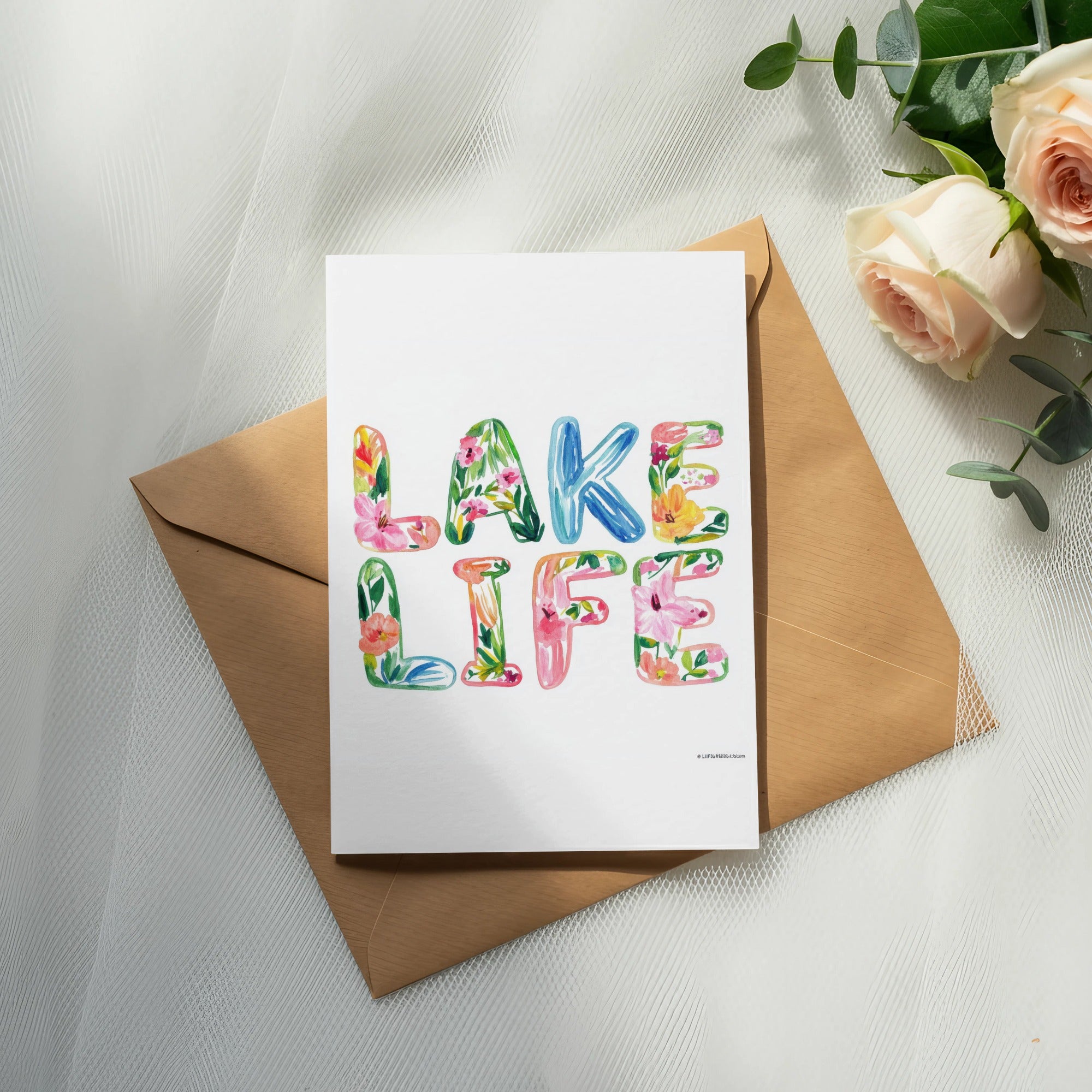 Card with "Lake Life" in colorful floral letters on a brown envelope.