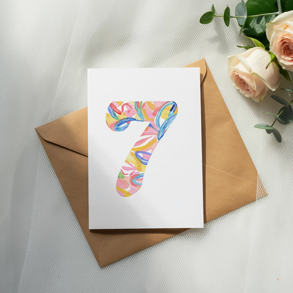 Card with colorful abstract number 7 design on a kraft envelope.