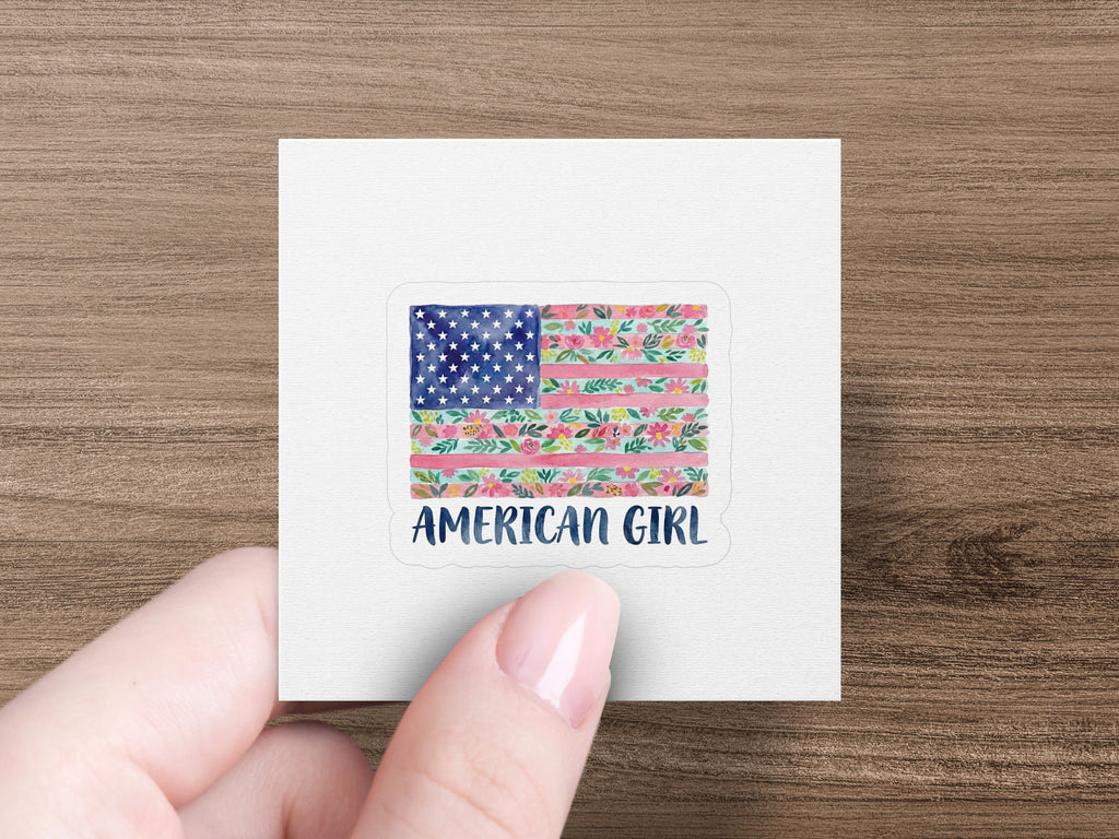 Square sticker featuring an American flag design with floral accents and "AMERICAN GIRL" text.