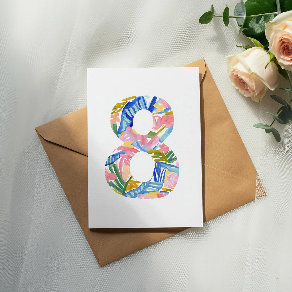 Card with colorful abstract number 8 design on brown envelope, roses.