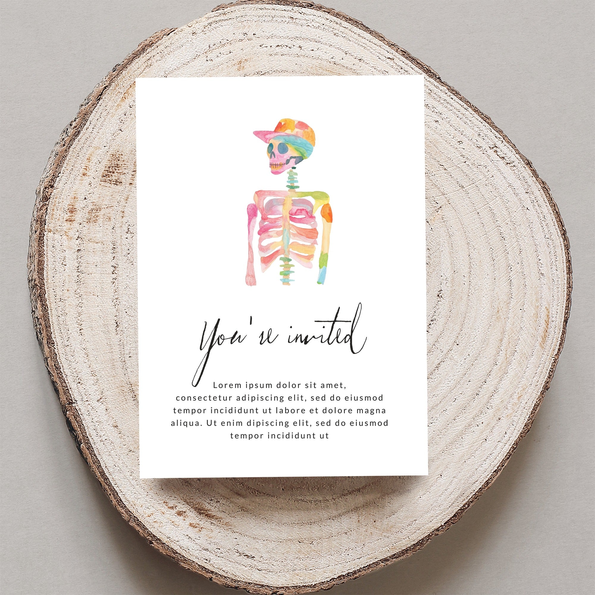 Watercolor skeleton with colorful cap, "You're invited" text, and placeholder copy.