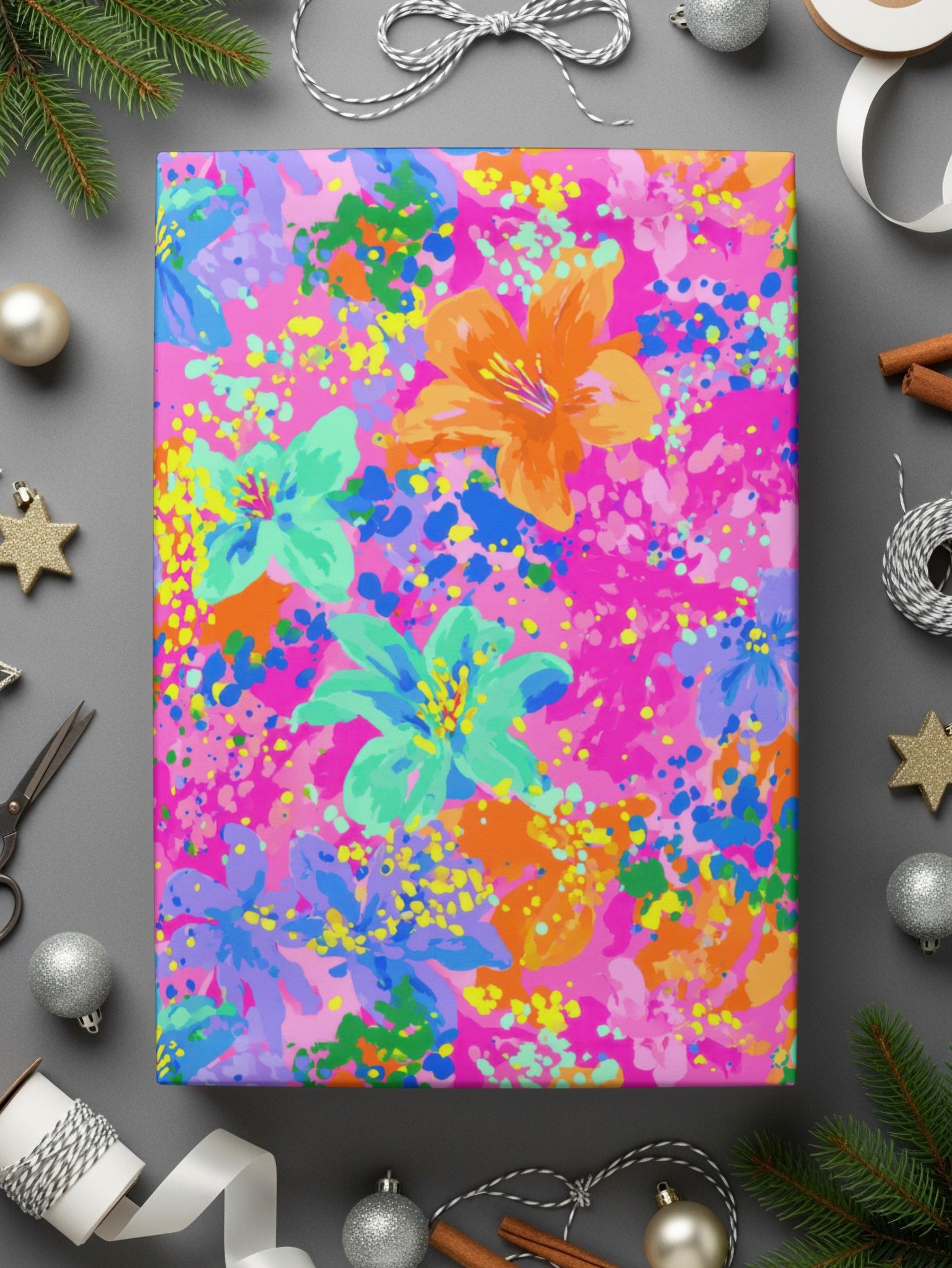 Pink wrapping paper with abstract floral pattern and confetti accents.