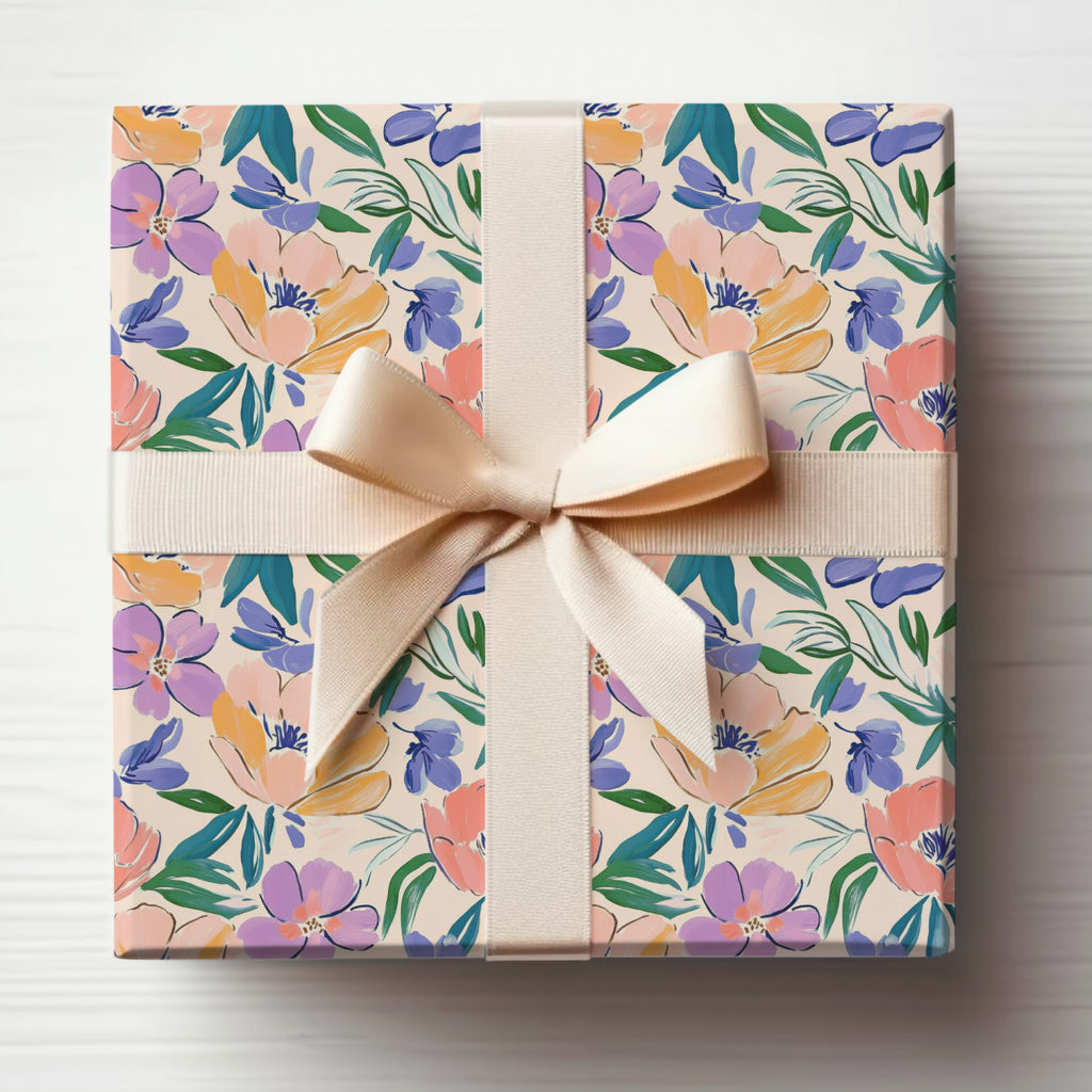 Gift box with floral pattern and light beige ribbon bow.