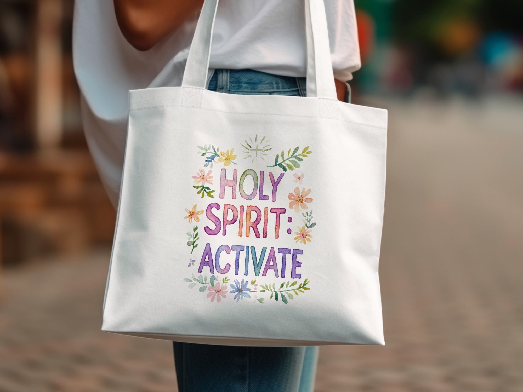 White tote bag with "Holy Spirit: Activate" text surrounded by floral watercolor design.