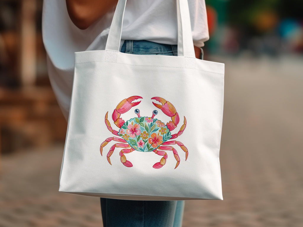 White tote bag with a colorful crab design made of flowers.