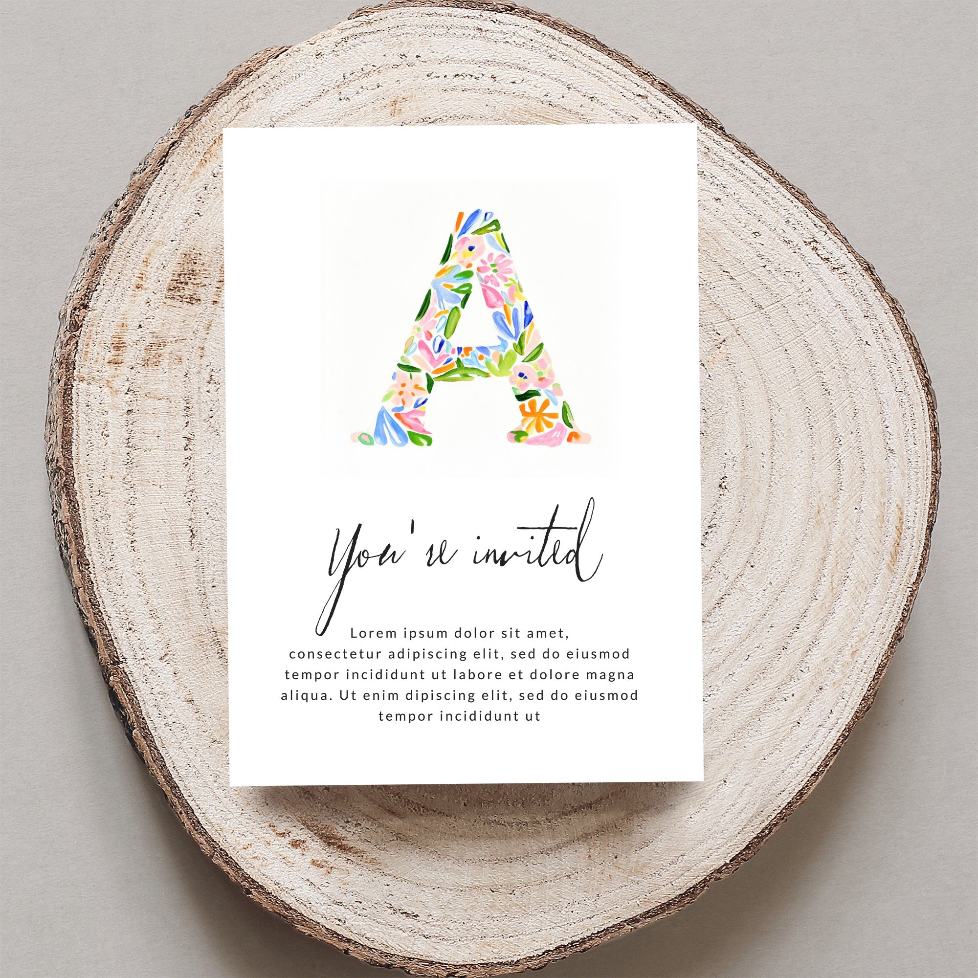 Invitation card with large floral letter "A" and "You're invited" text.