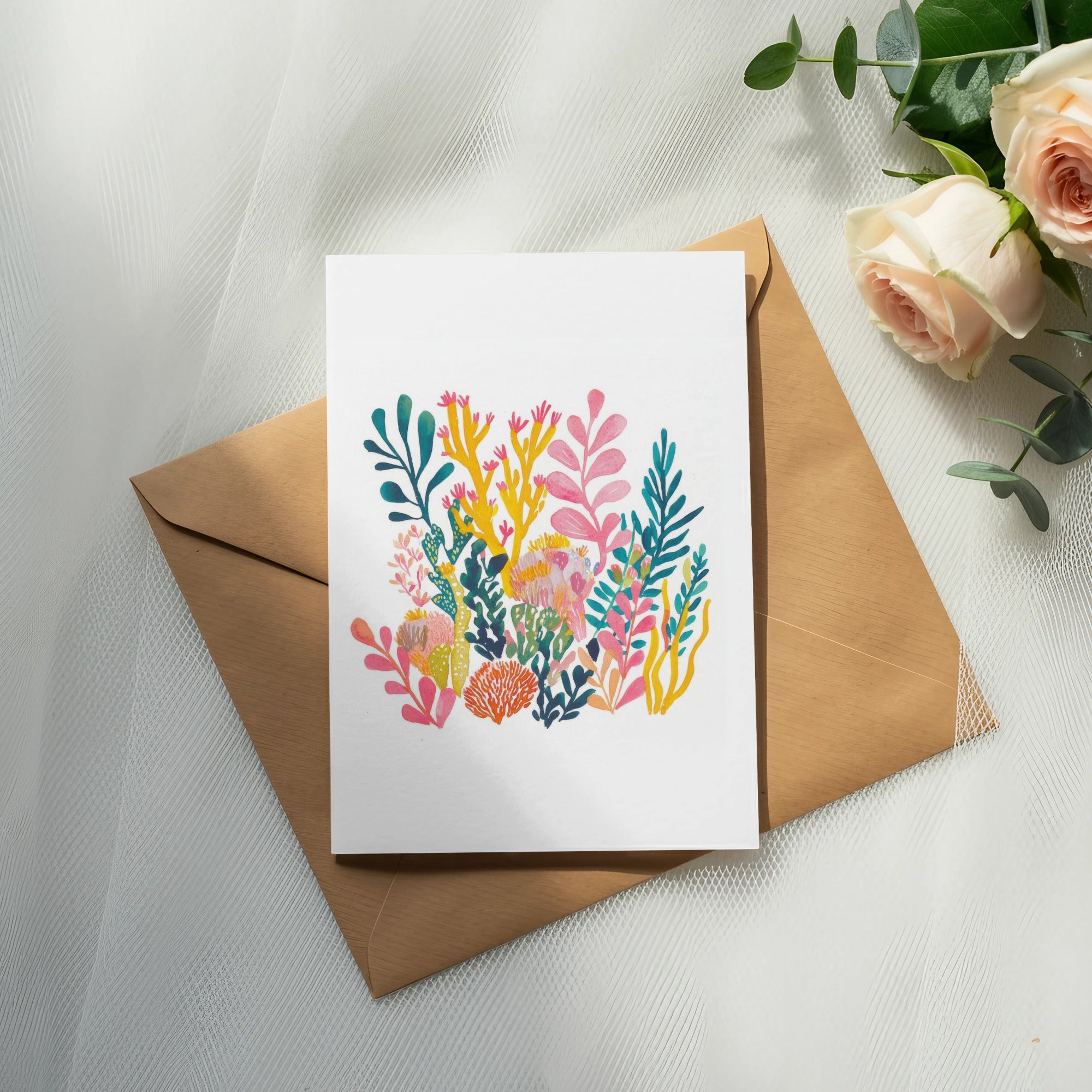 Card with colorful coral reef illustration on a kraft envelope with roses.