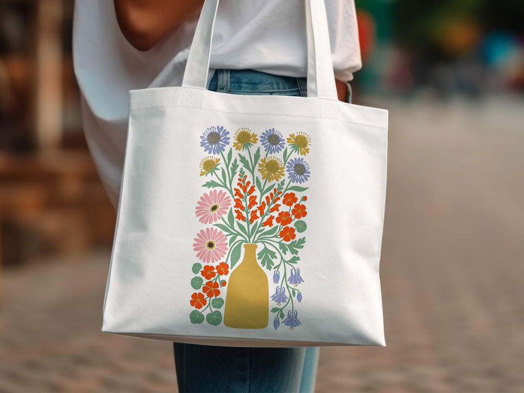 White canvas tote bag with a colorful bouquet of wildflowers and blossoms.