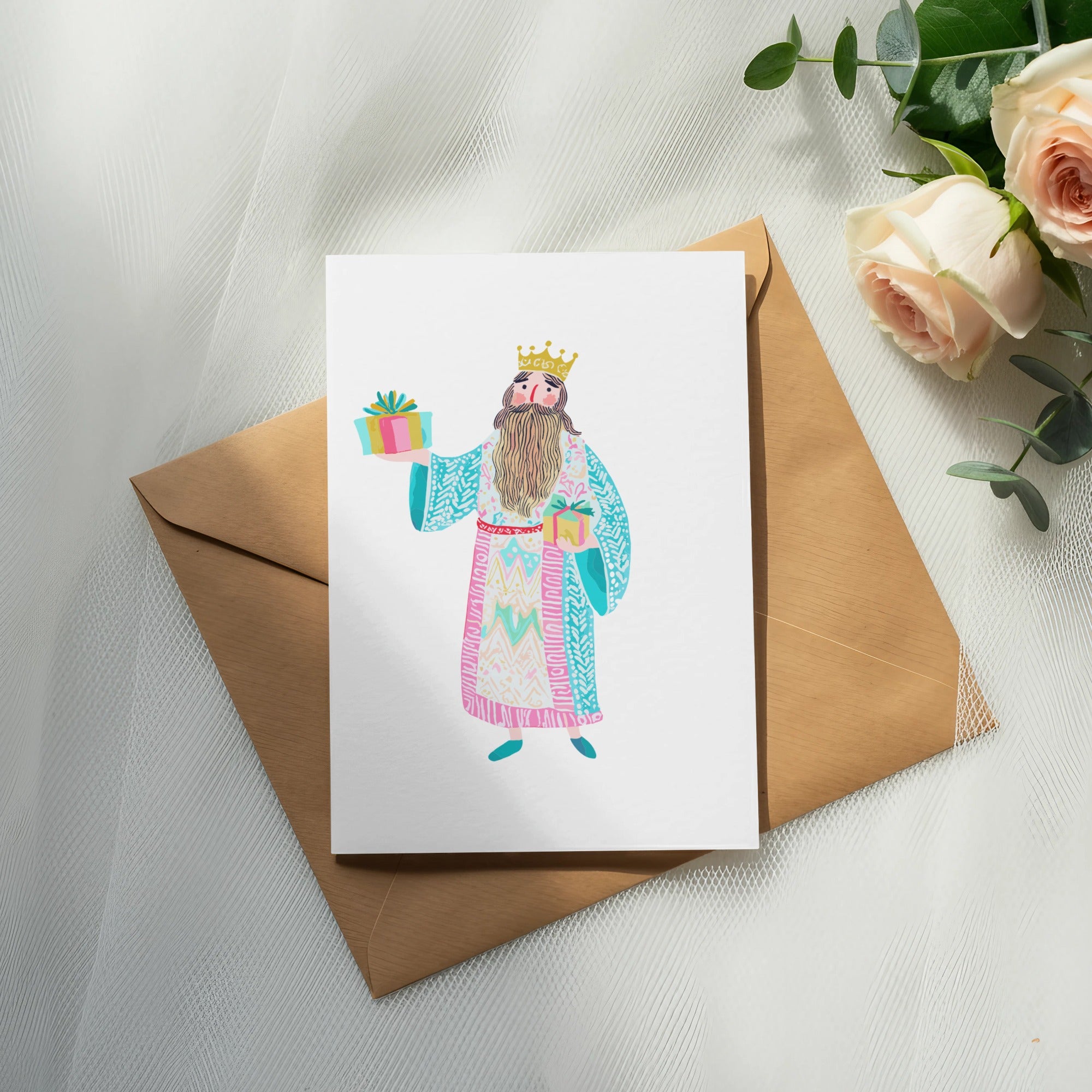 Card with illustration of king holding gift, placed on envelope.