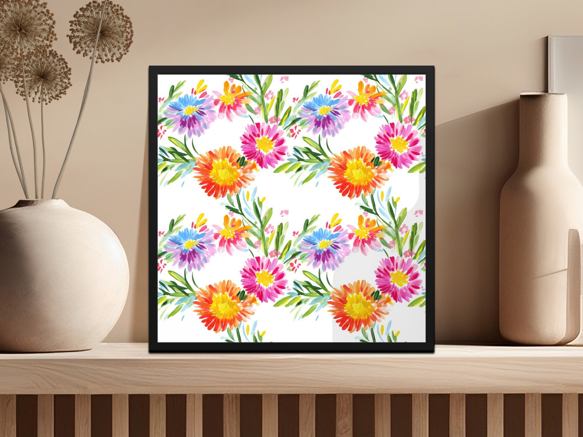 Framed artwork with colorful floral watercolor pattern on a shelf.