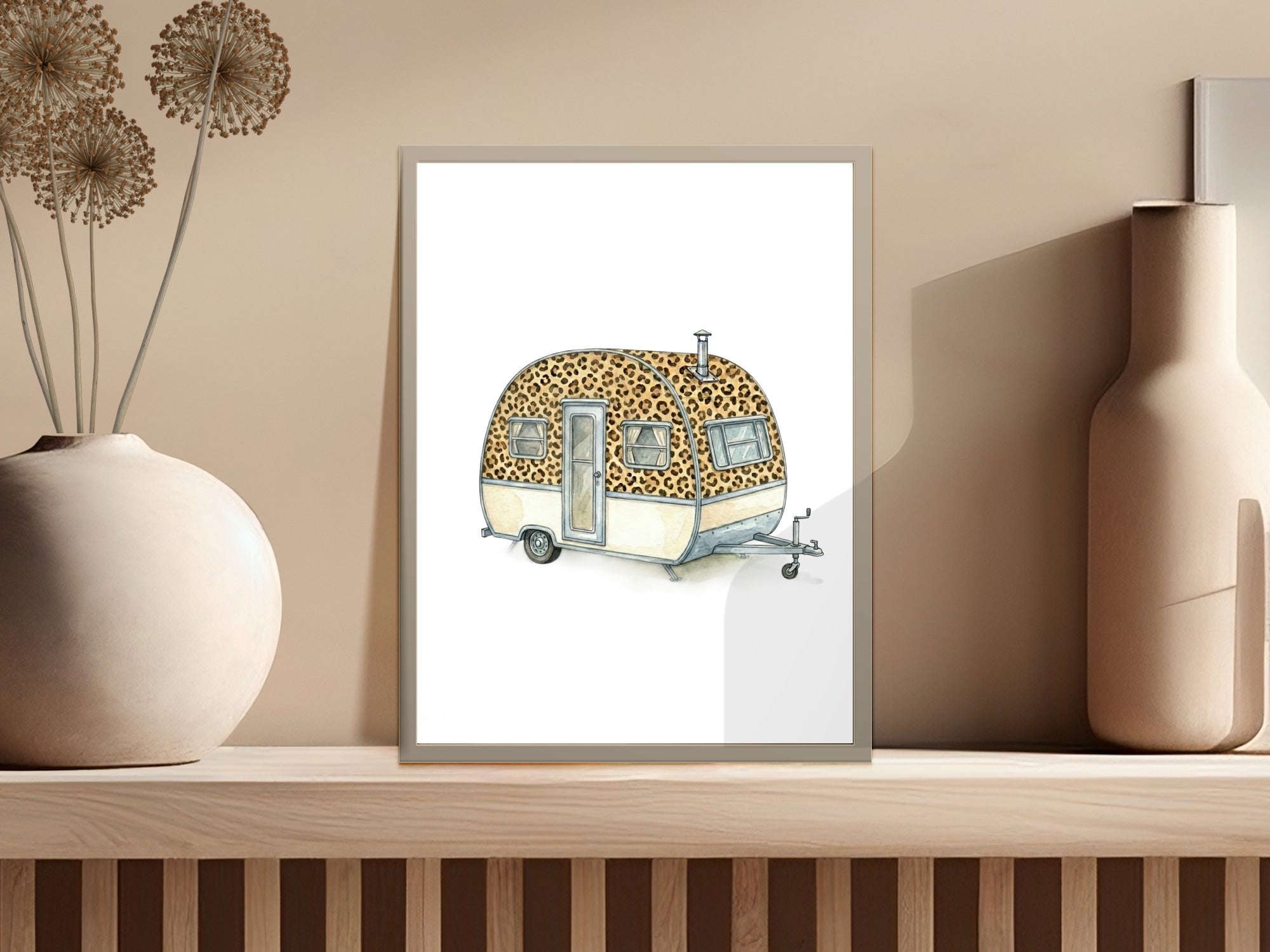 Watercolor illustration of a retro caravan with leopard print accents on a shelf.