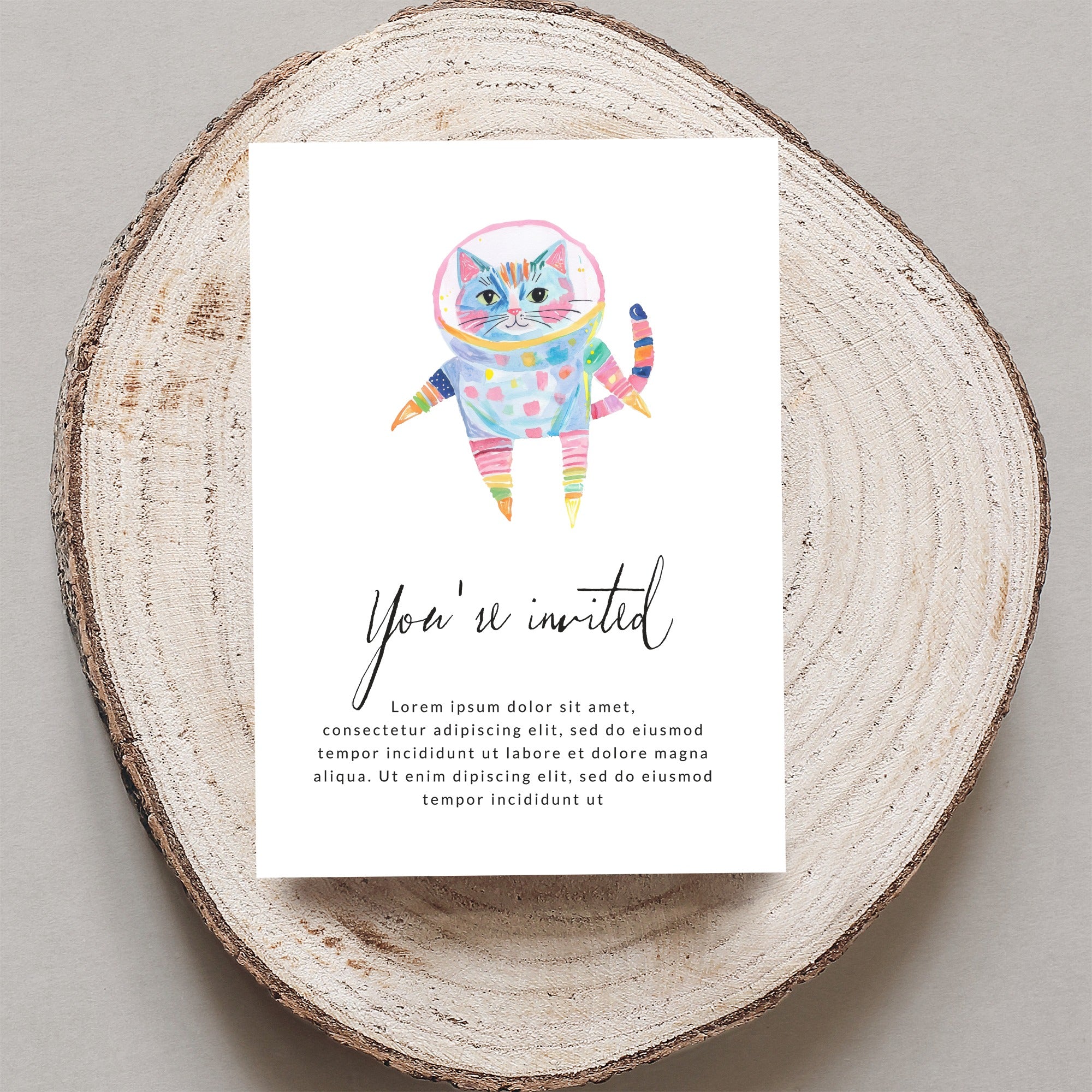 Watercolor astronaut cat with colorful stripes on an invitation.