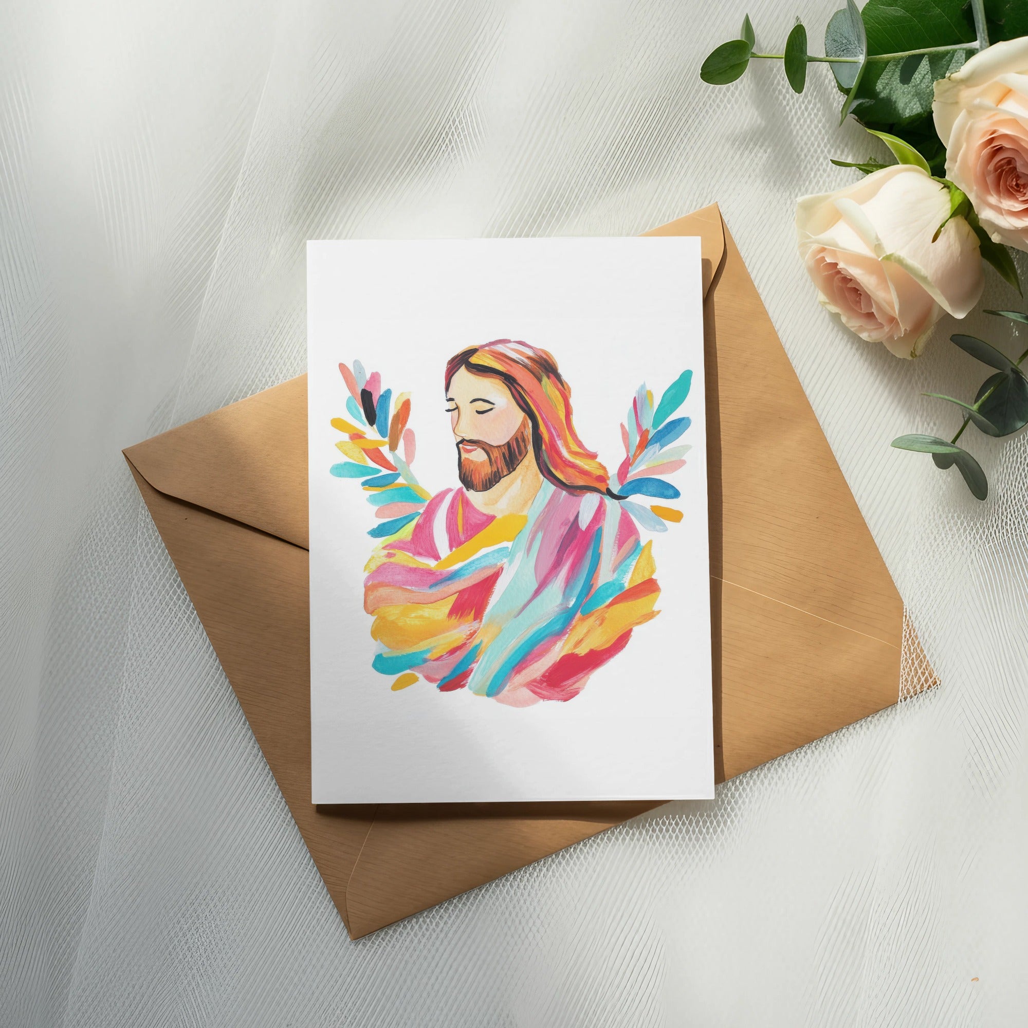 Painting of Jesus with colorful halo, on brown envelope with roses.
