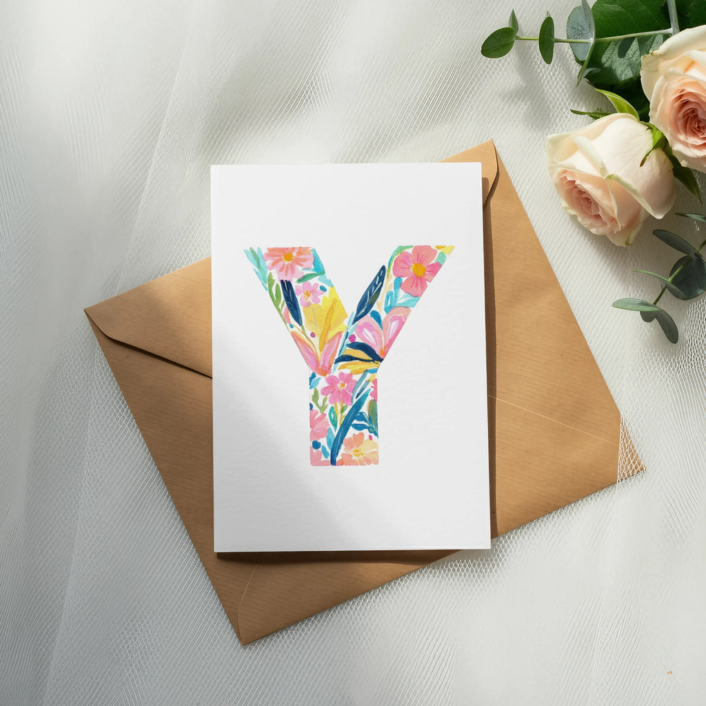 White card with a colorful floral letter Y on a brown envelope.