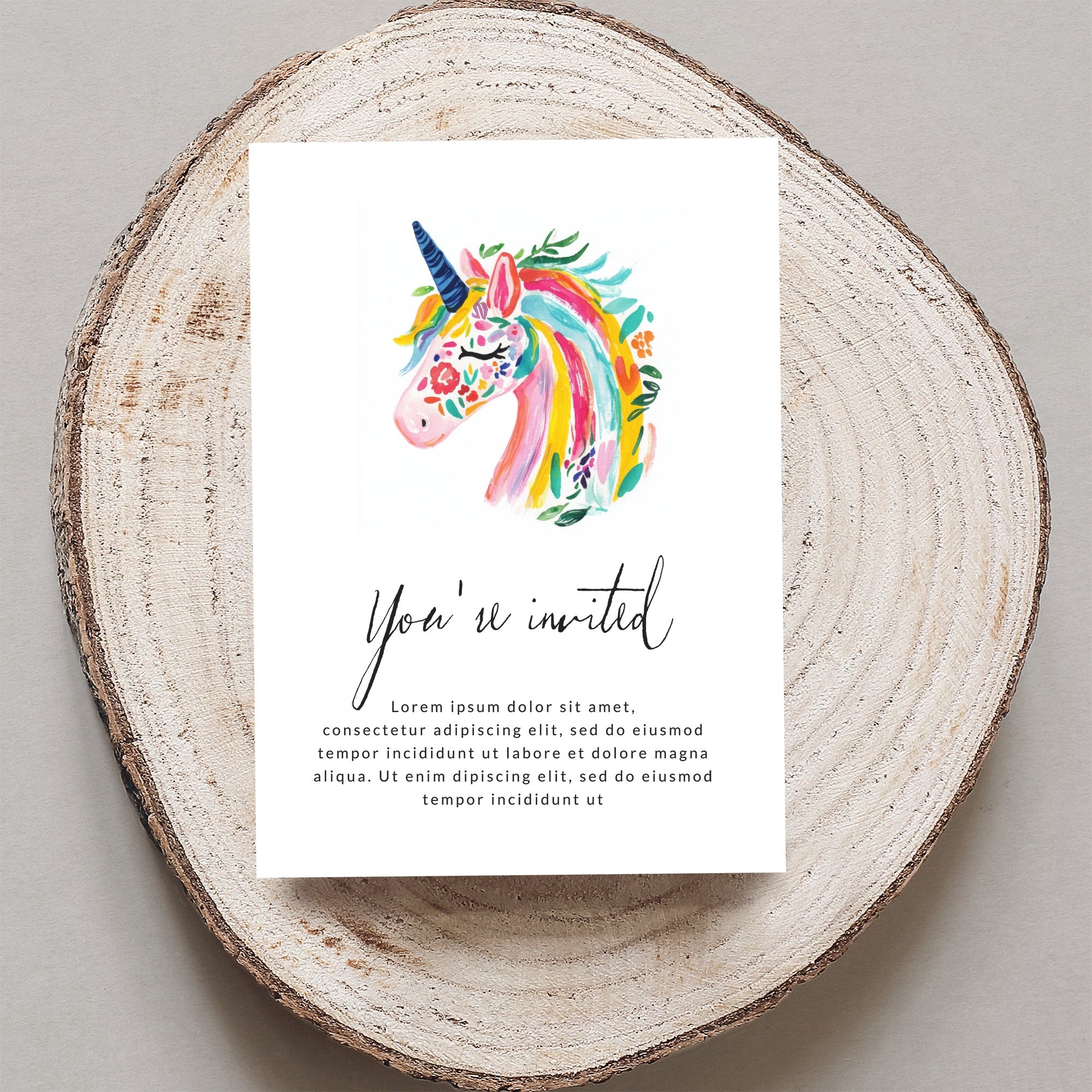 Invitation with colorful watercolor unicorn and "You're invited" text.