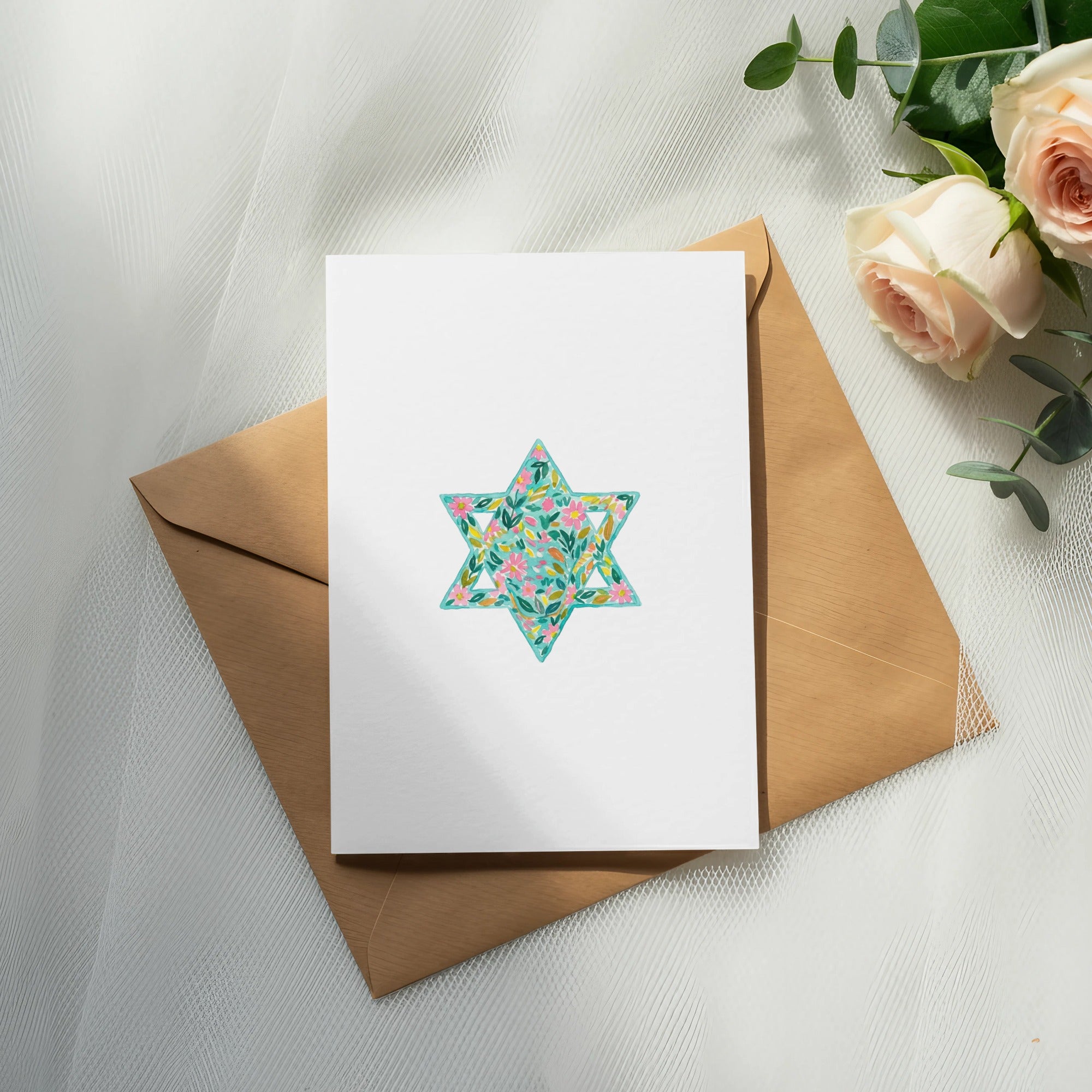 Card with a floral Star of David design on a kraft envelope.