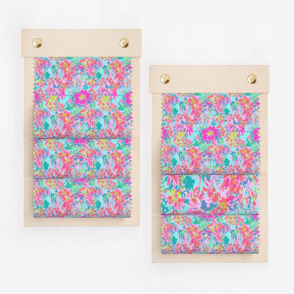 Two swatch books with colorful floral fabric samples.