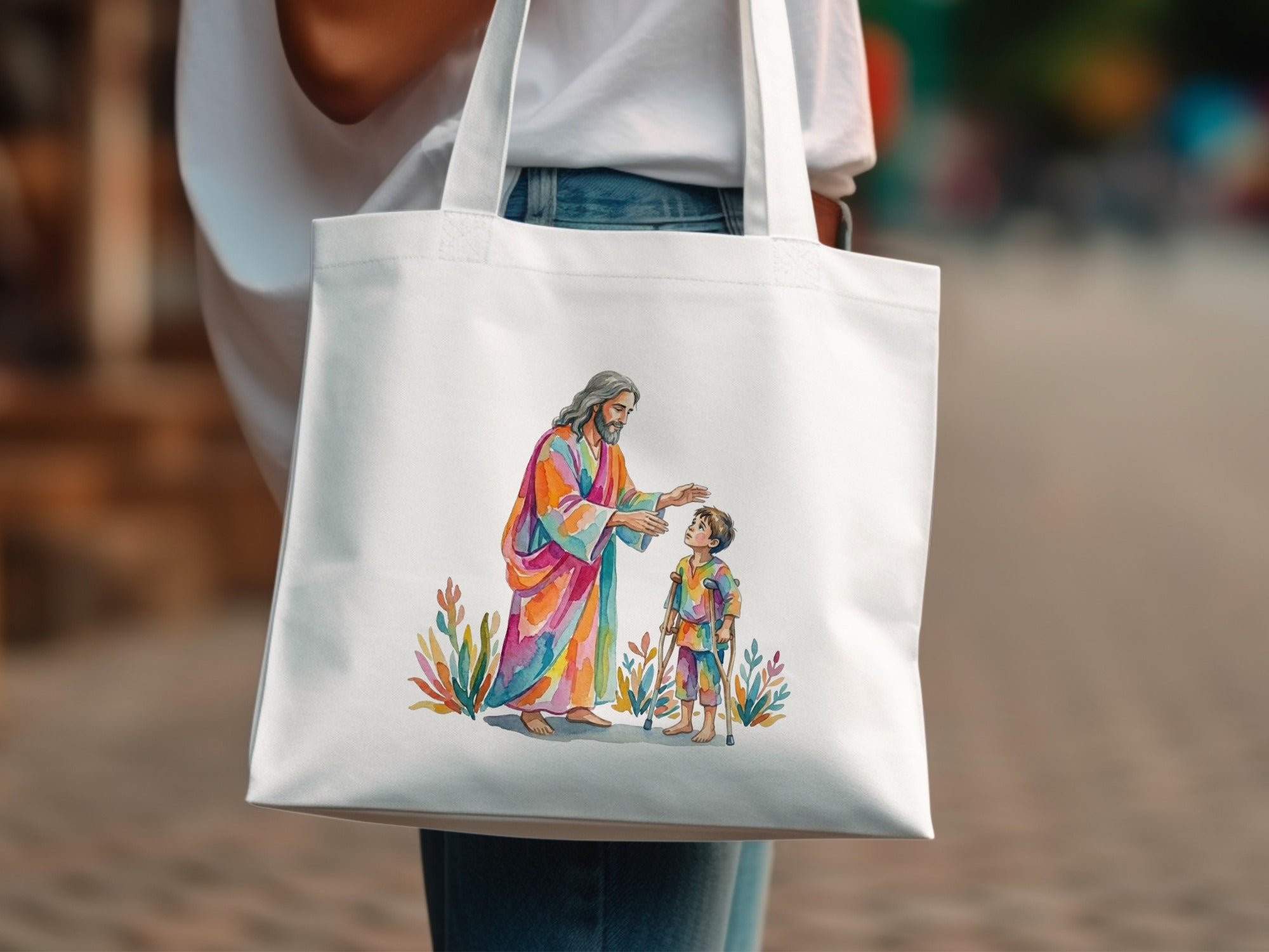Jesus in colorful robes blesses a child with crutches on a tote bag.